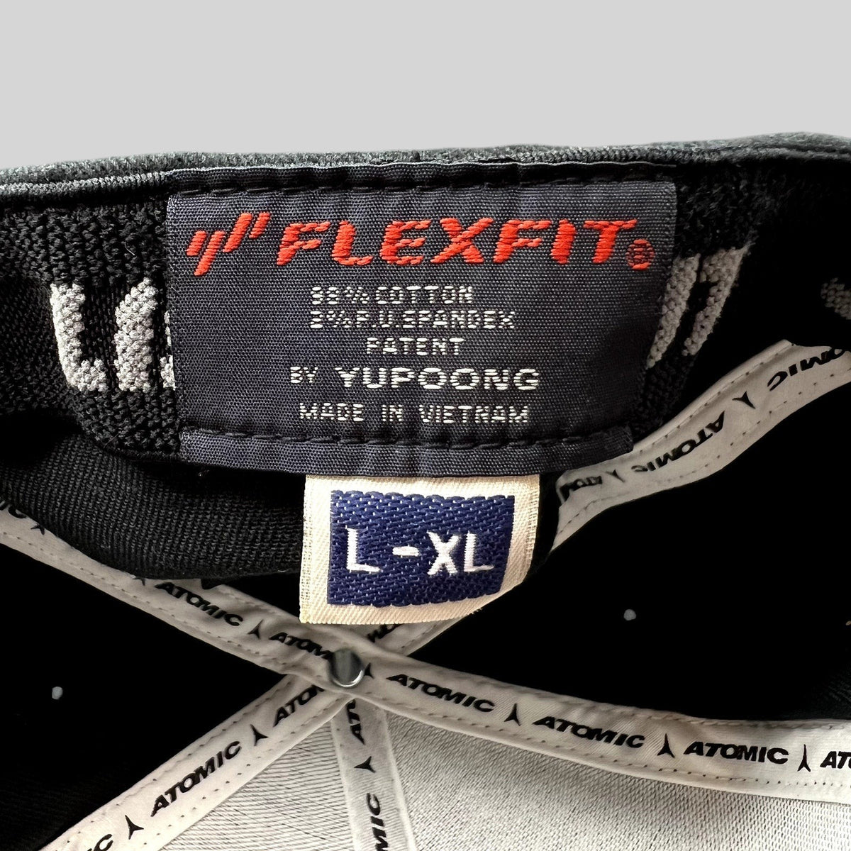 Raree Finds Atomic Skis FlexFit cap interior label showing size L-XL and Yupoong branding