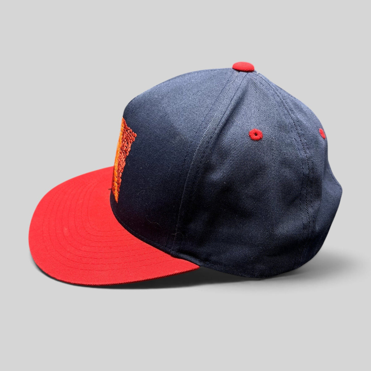 Raree Finds Atomic Skis navy and red snapback hat with embroidered Eiffel Tower mosaic graphic on the front