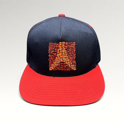 Raree Finds Atomic Skis navy snapback hat with a red flat brim and embroidered orange Eiffel Tower mosaic graphic