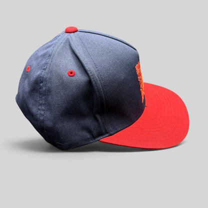 Raree Finds Atomic Skis navy and red snapback hat with embroidered Eiffel Tower mosaic graphic on the front