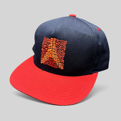Raree Finds Atomic Skis navy snapback hat with red flat brim and embroidered orange Eiffel Tower mosaic graphic