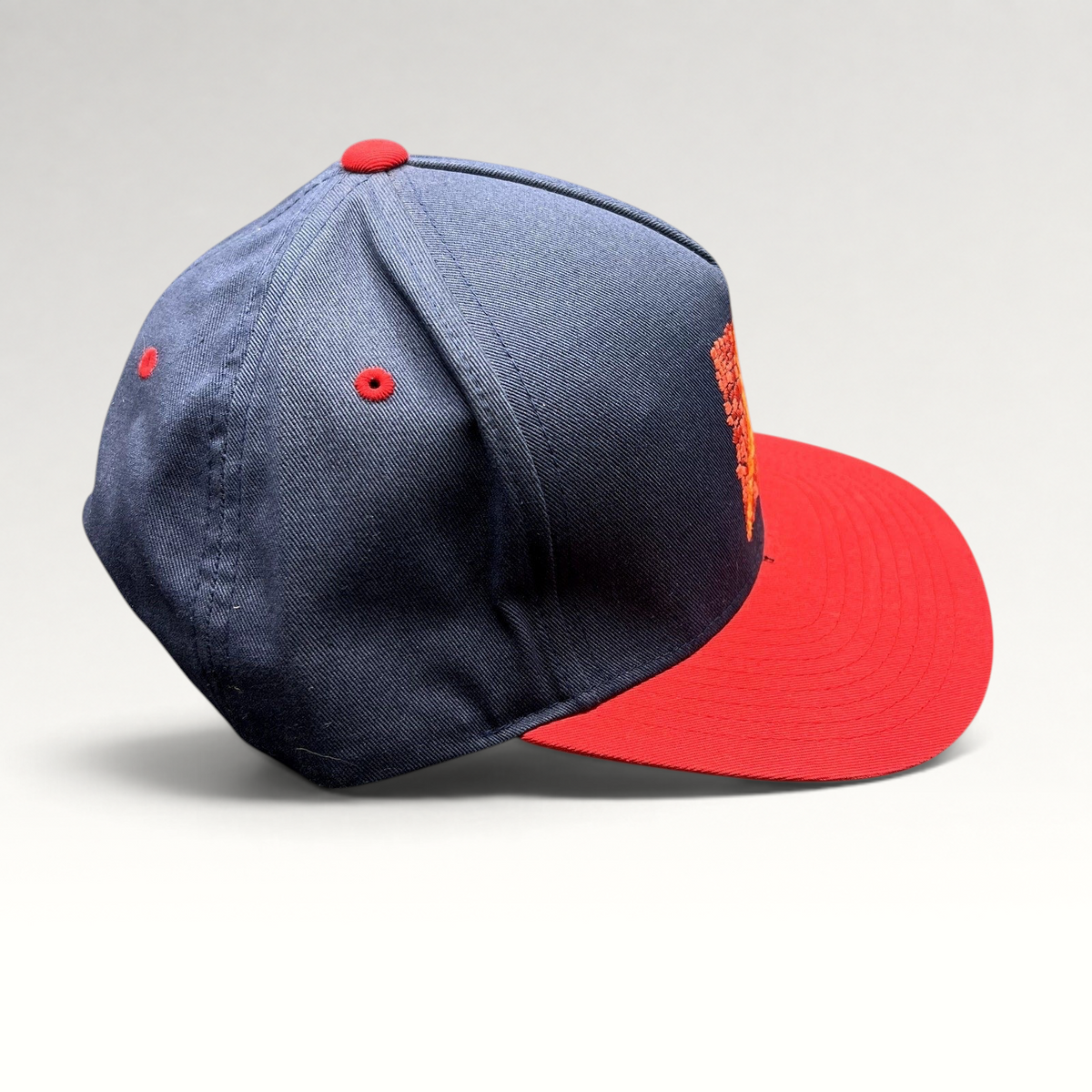 Raree Finds Atomic Skis navy and red snapback hat with embroidered Eiffel Tower mosaic graphic on the front