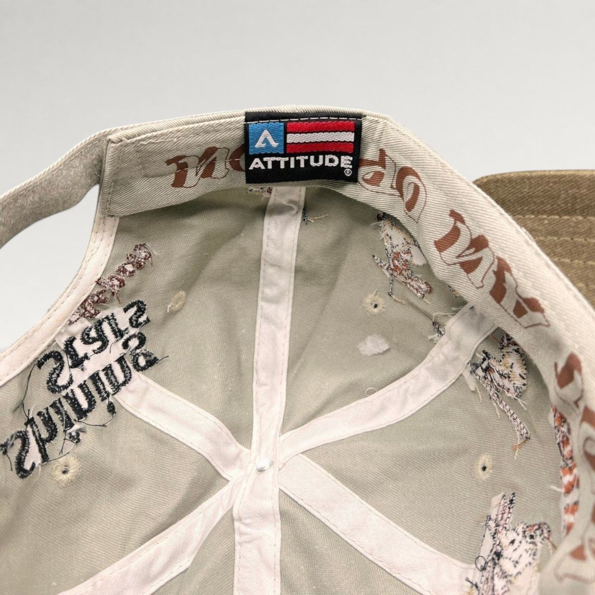 Raree Finds vintage Attitude brand strapback interior showing embroidered skier details and branded woven label