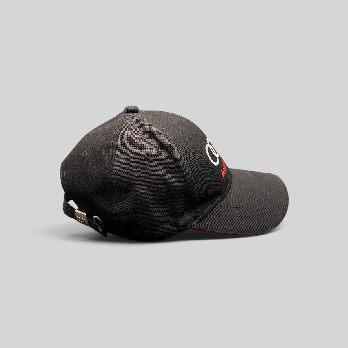 Raree Finds black cotton twill Audi strapback hat with embroidered logo and red under-brim detail