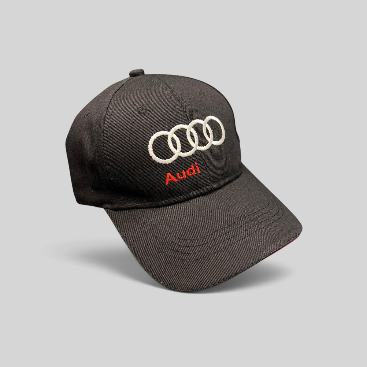 Raree Finds black cotton twill Audi strapback hat with white interlocking rings and red logo embroidery