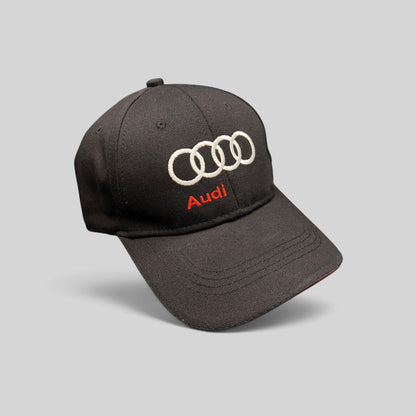 Raree Finds black cotton twill Audi strapback hat with white interlocking rings and red logo embroidery