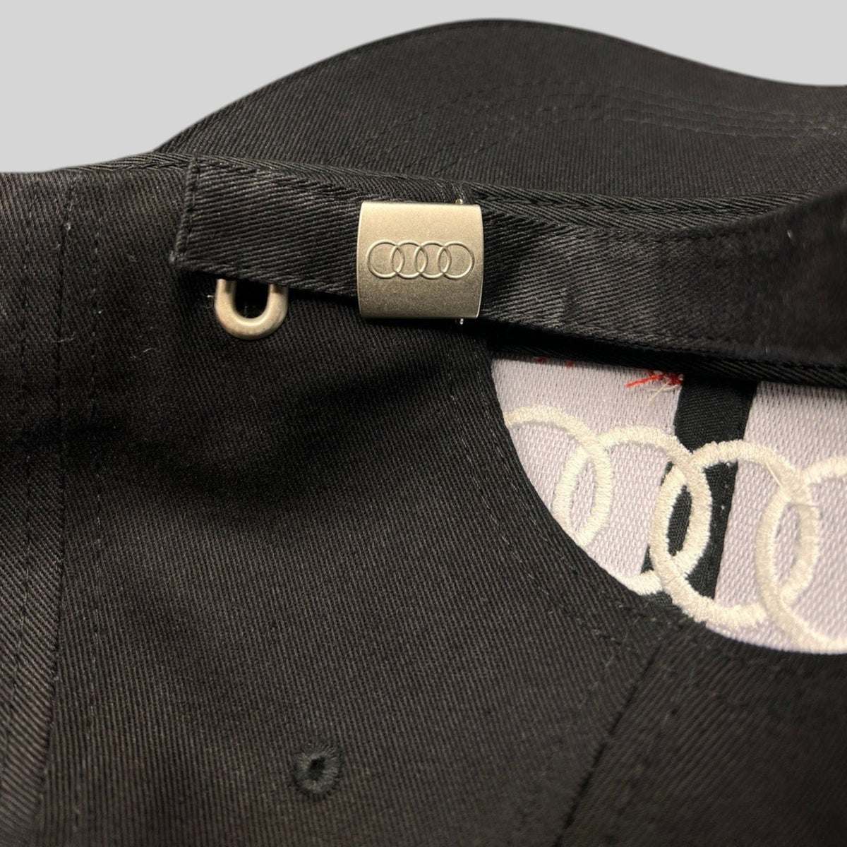 Raree Finds black cotton twill Audi hat featuring an adjustable strapback with an engraved metal logo clasp