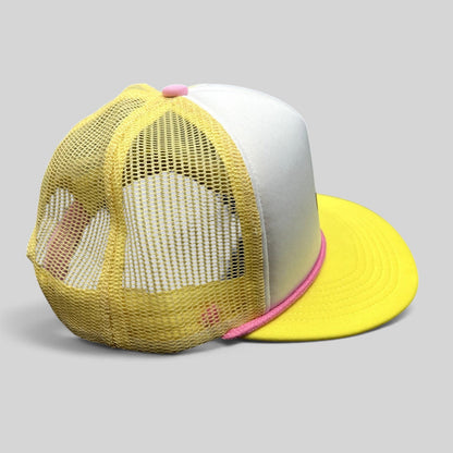 Raree Finds Baby Bum prototype trucker hat with yellow mesh back, white foam front, and pink rope trim detail.