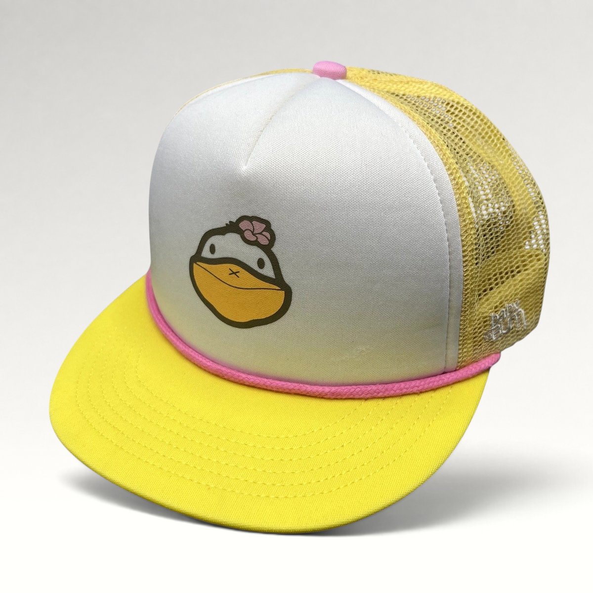 Raree Finds Baby Bum prototype trucker hat with yellow brim, white foam front, duck graphic, and pink rope detail.