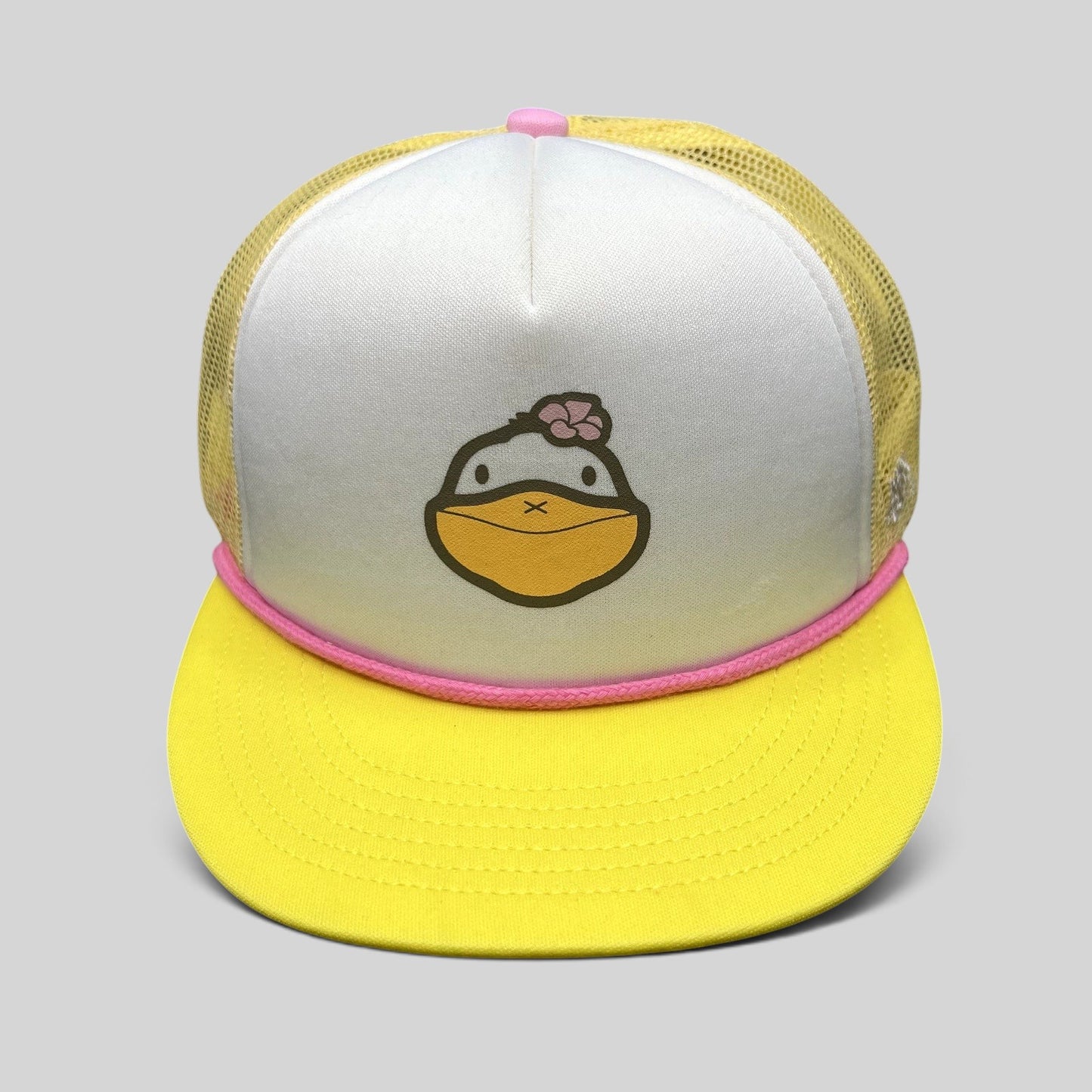Raree Finds Baby Bum prototype trucker hat with white foam front, yellow mesh back, pink rope trim, and duck graphic.