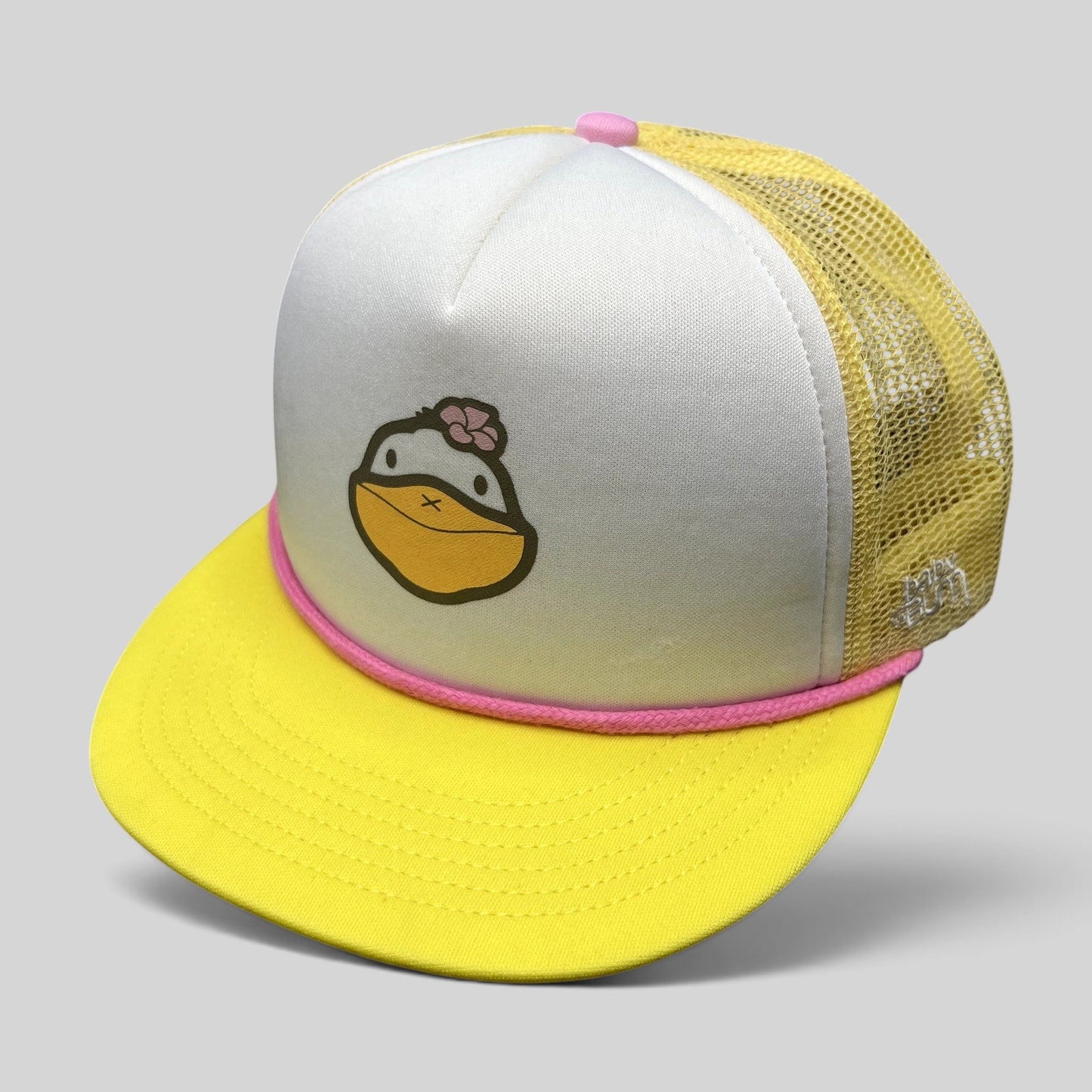 Raree Finds Baby Bum prototype trucker hat with white foam front, yellow mesh back, pink rope trim, and duck graphic.