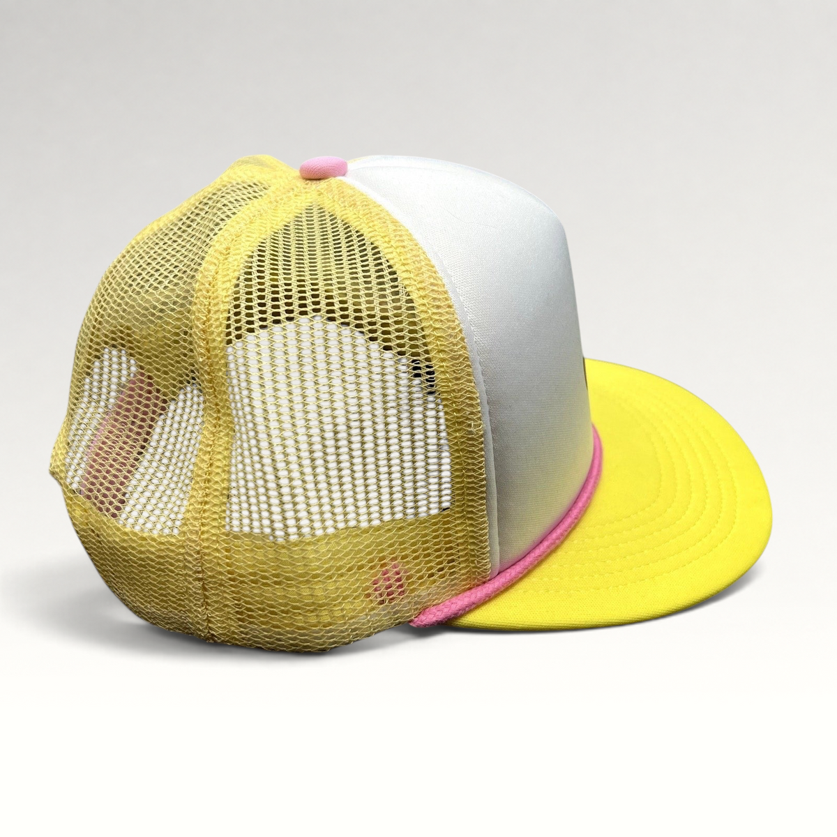 Raree Finds Baby Bum prototype trucker hat in yellow and white with pink rope trim and mesh back panels