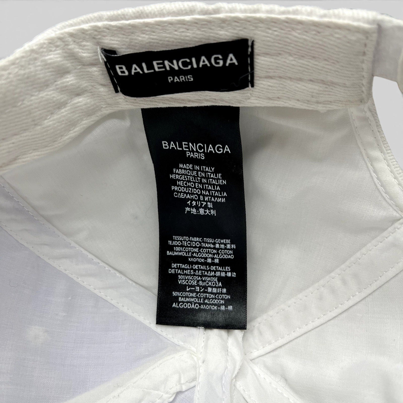 Raree Finds Balenciaga hat interior label showing multilingual Made in Italy details on white cotton fabric