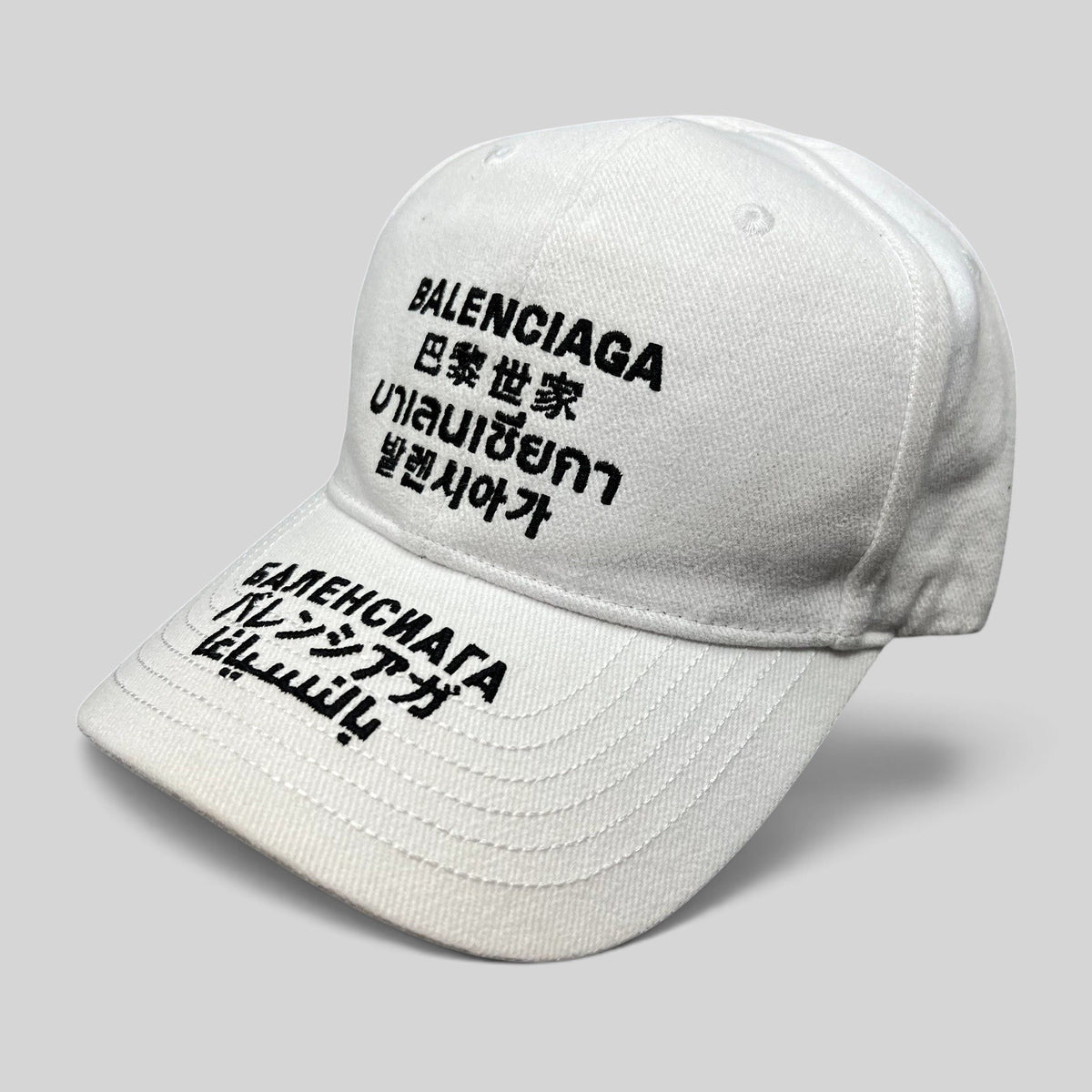 Raree Finds white Balenciaga cotton strapback hat with black multilingual logo embroidery on front and brim