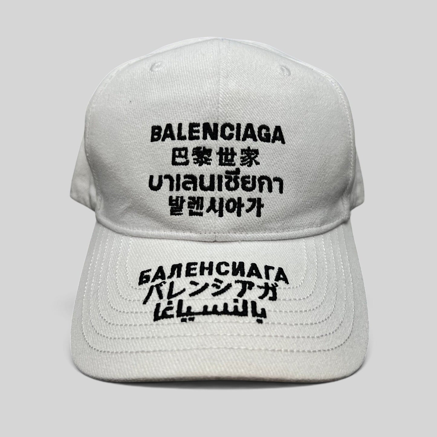 Raree Finds white cotton strapback hat with black multilingual Balenciaga logo embroidery on front and brim