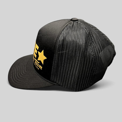 Raree Finds black and gold Barre Vermont trucker snapback hat with mesh back panels and Ski Town All-Stars branding.