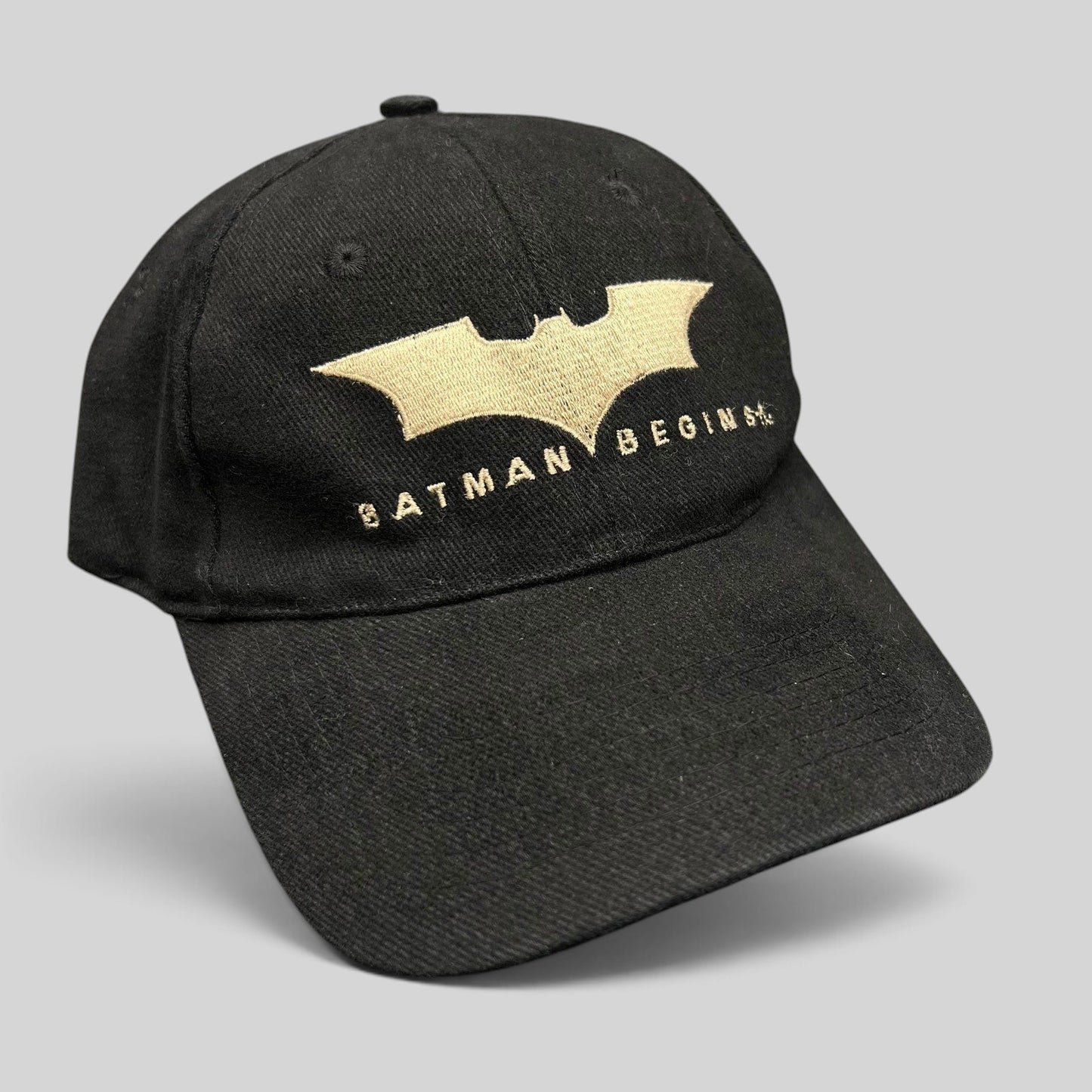 Raree Finds vintage 2005 Batman Begins black cotton strapback hat with gold embroidered bat symbol and movie logo