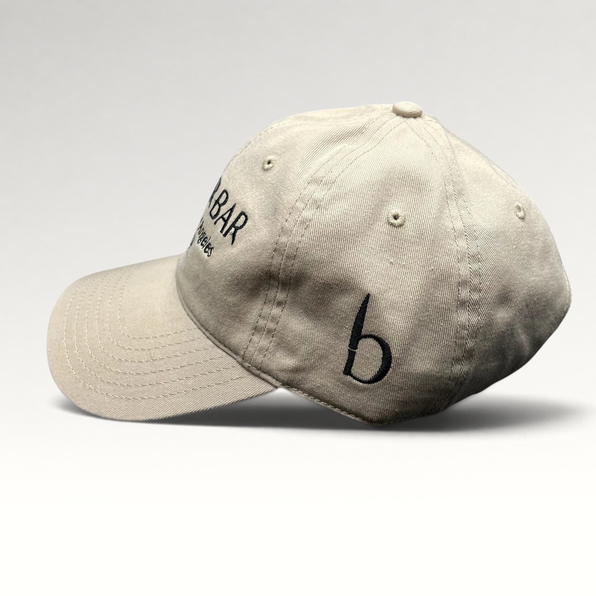 Raree Finds beige cotton twill strapback hat with black Butchr Bar embroidery and side logo detail