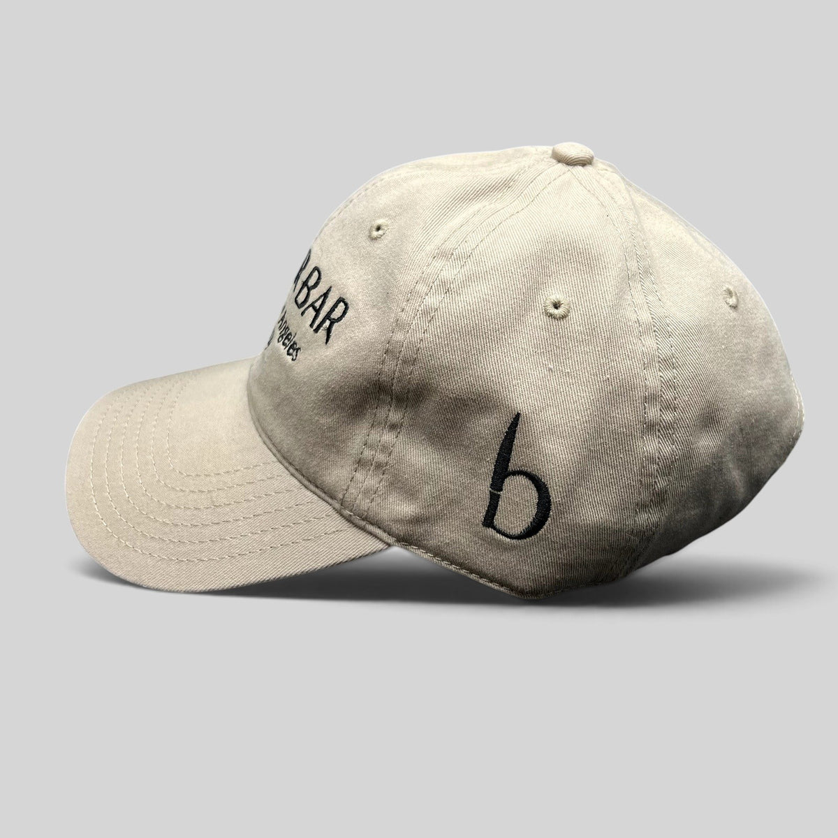 Raree Finds beige cotton twill strapback hat with black Butchr Bar embroidery and side logo detail