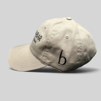 Raree Finds beige cotton twill strapback hat with black Butchr Bar embroidery and side logo detail