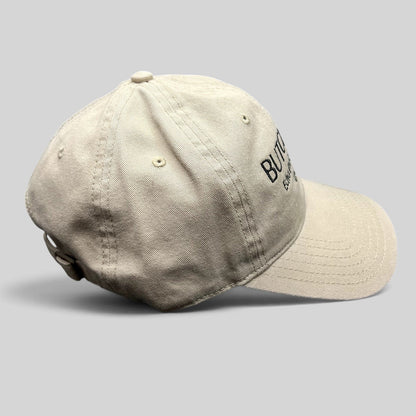 Raree Finds beige cotton twill strapback hat with black Butchr Bar Echo Park Los Angeles embroidery, side view.