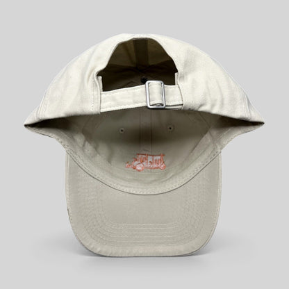 Raree Finds beige Tuk Tuk Thai strapback hat showing the adjustable metal buckle closure and interior branding