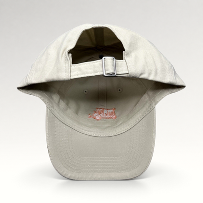 Raree Finds beige Tuk Tuk Thai strapback hat showing the adjustable metal buckle closure and interior branding