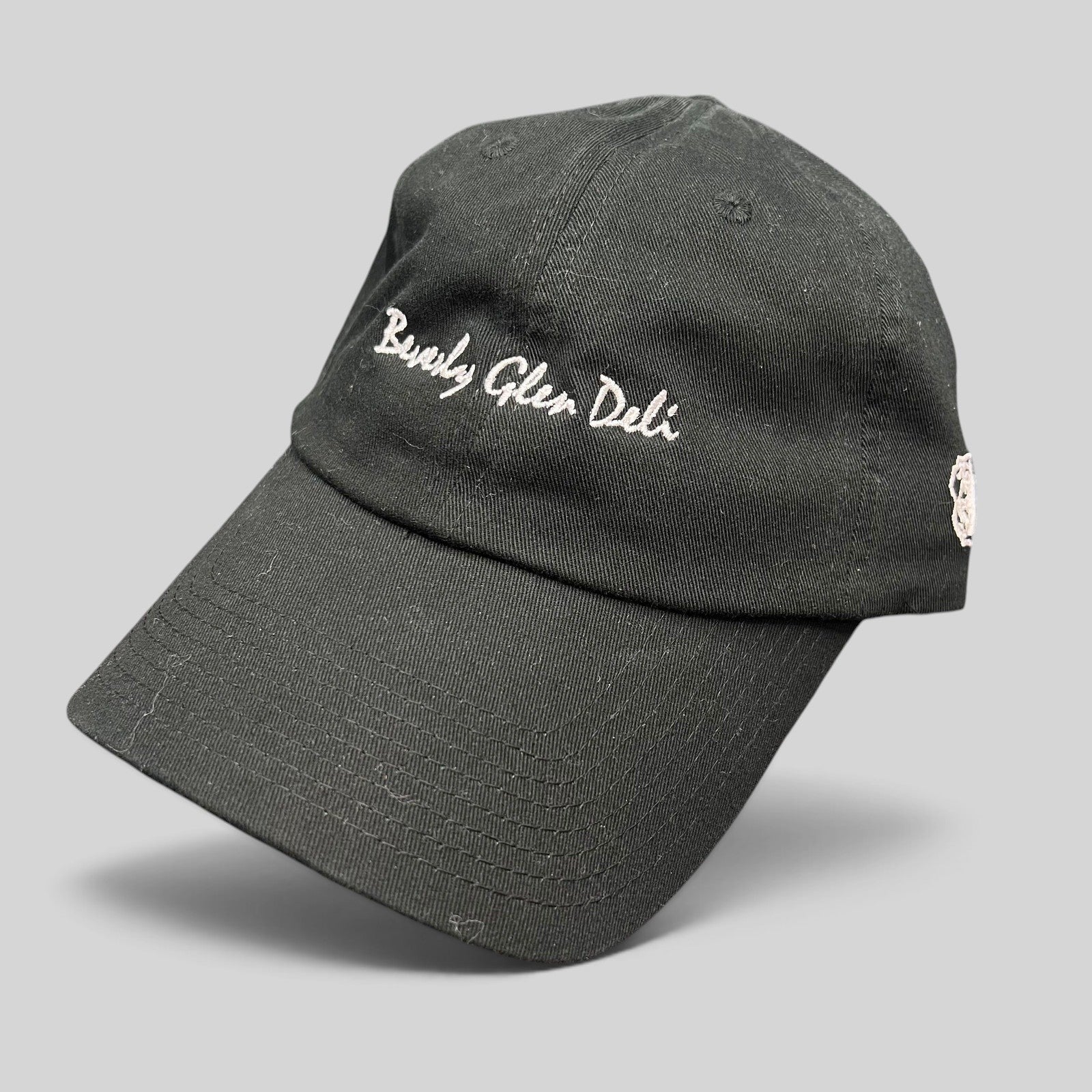 Raree Finds black cotton strapback hat with white Beverly Glen Deli cursive script embroidery and curved bill