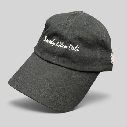 Raree Finds black cotton strapback hat with white Beverly Glen Deli cursive script embroidery and curved bill
