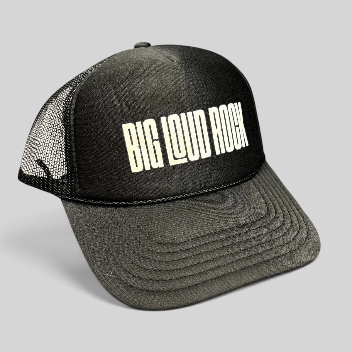 Raree Finds black and white Big Loud Rock trucker hat with foam front, mesh back, and adjustable snapback closure.