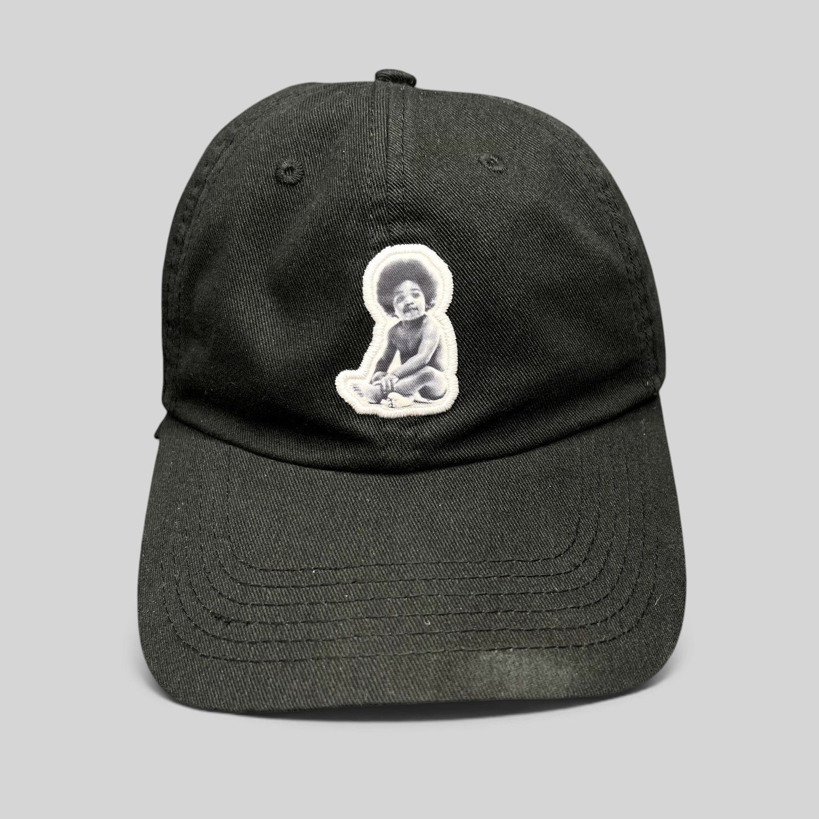 Raree Finds black strapback hat featuring an embroidered Notorious B.I.G. Ready To Die baby graphic patch