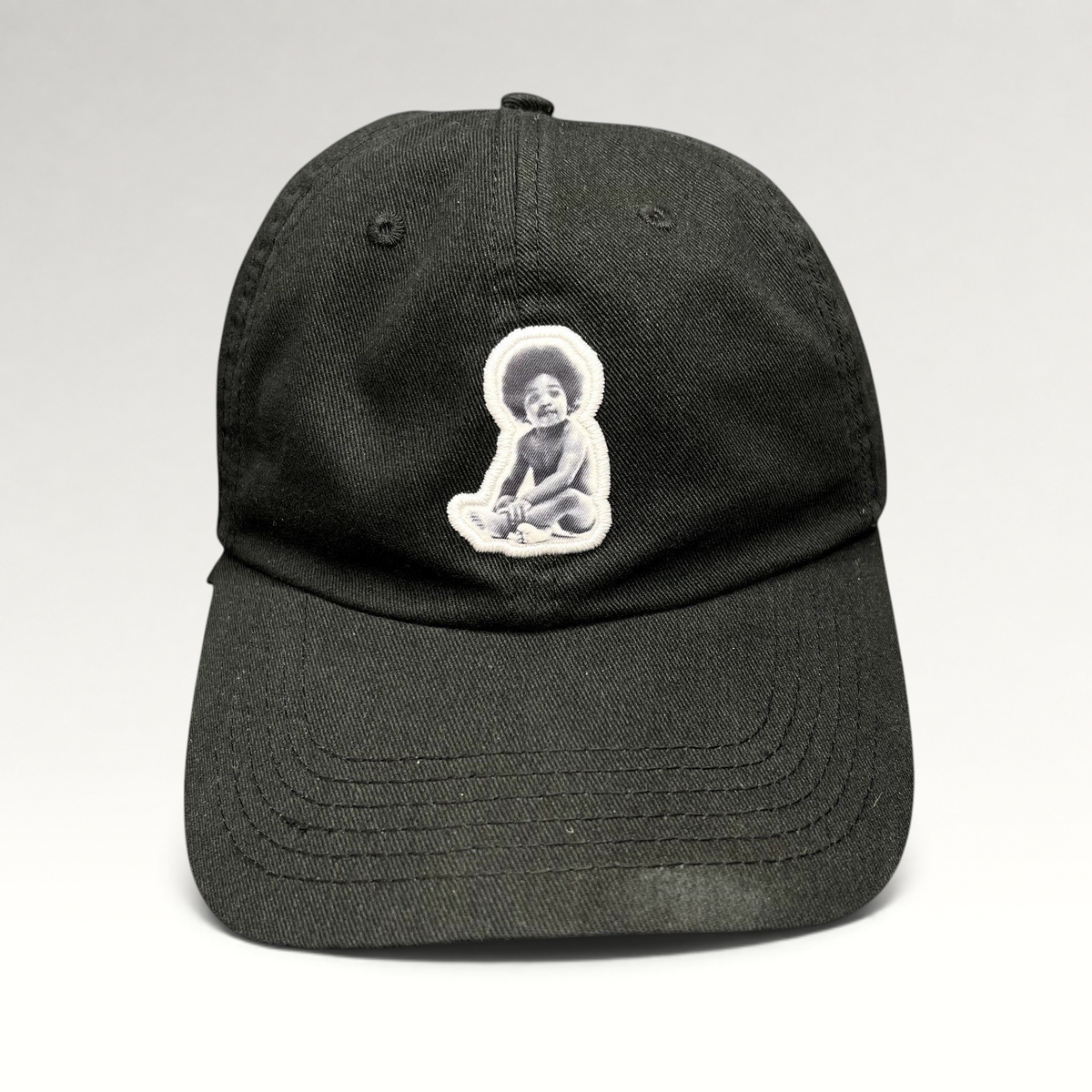 Raree Finds black strapback hat featuring an embroidered Notorious B.I.G. Ready To Die baby graphic patch