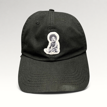 Raree Finds black strapback hat featuring an embroidered Notorious B.I.G. Ready To Die baby graphic patch