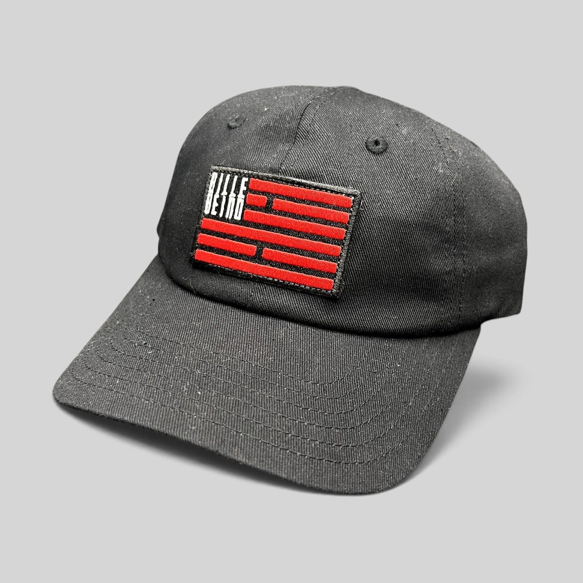Raree Finds BilleBeino black strapback hat with a red embroidered geometric flag logo on the front crown