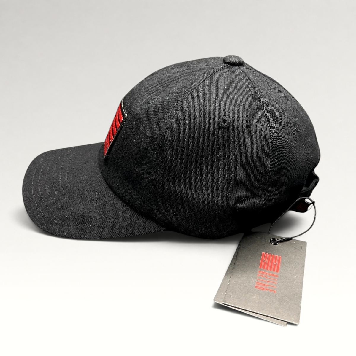 Raree Finds BilleBeino black strapback hat with red embroidered flag logo and original tags attached