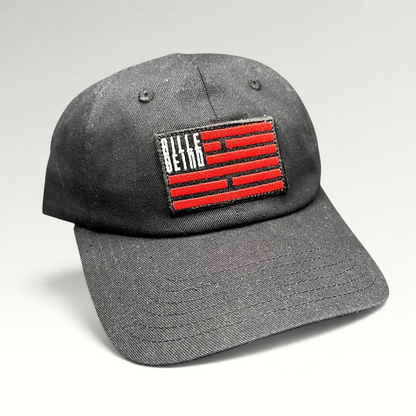 Raree Finds BilleBeino black strapback hat with a red embroidered geometric flag logo on the front crown