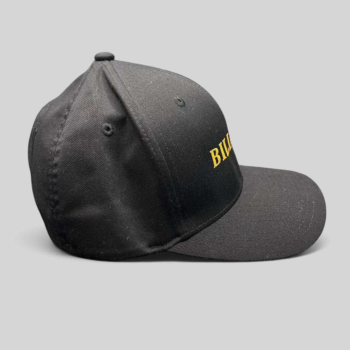 Raree Finds Billions TV show black Yupoong Flexfit hat with gold embroidered logo on a structured crown