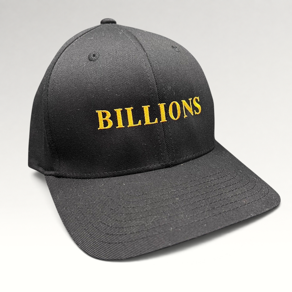 Raree Finds Billions TV show promotional black Yupoong Flexfit hat with gold embroidered logo on the front