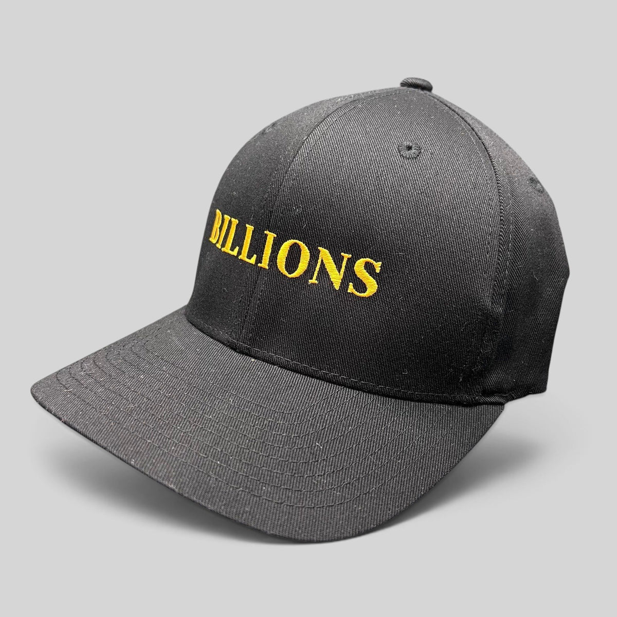 Raree Finds black Yupoong Flexfit hat with Billions TV show title embroidered in gold on the front