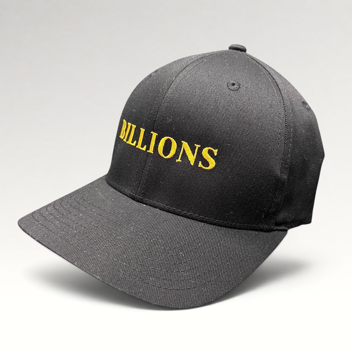 Raree Finds black Yupoong Flexfit hat with Billions TV show title embroidered in gold on the front