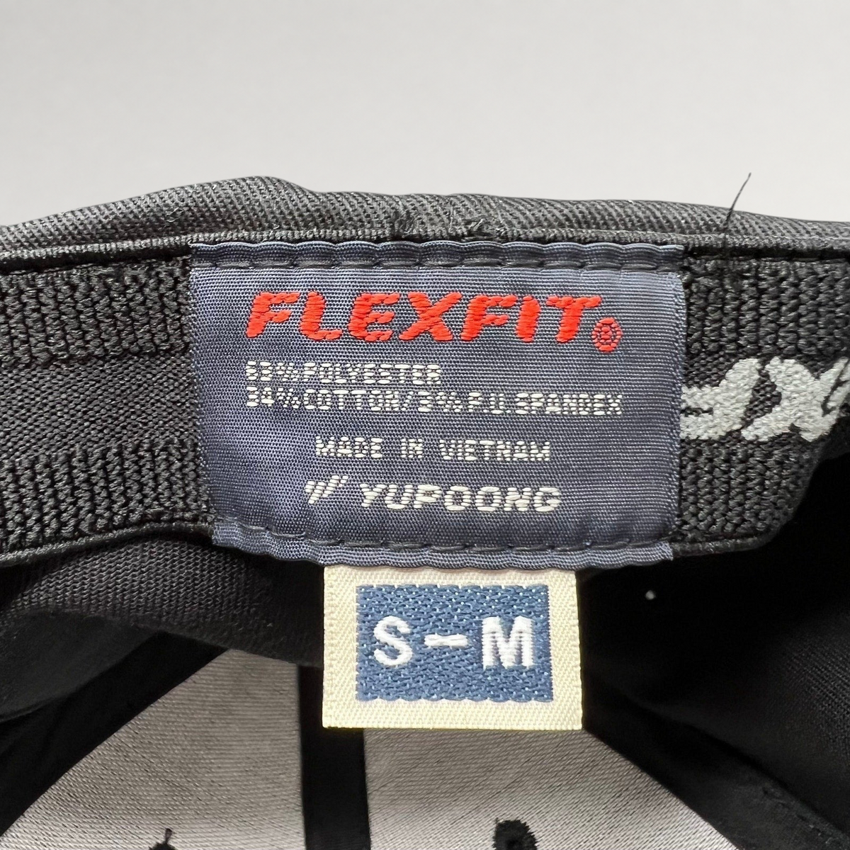 Raree Finds Billions TV show hat interior label showing Yupoong Flexfit branding and size S/M tag