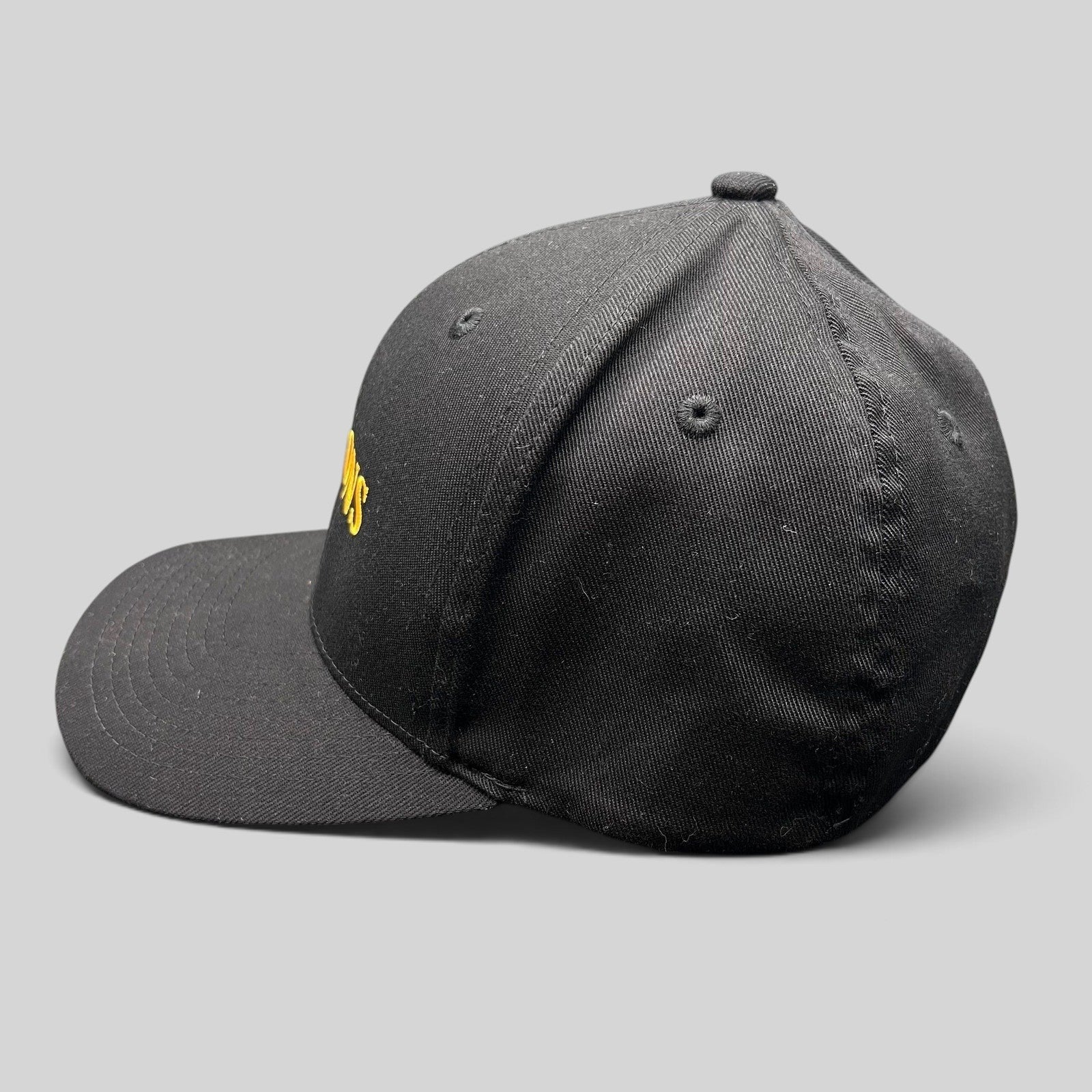 Raree Finds Billions TV show promotional black Yupoong Flexfit hat with gold embroidered logo on a structured crown