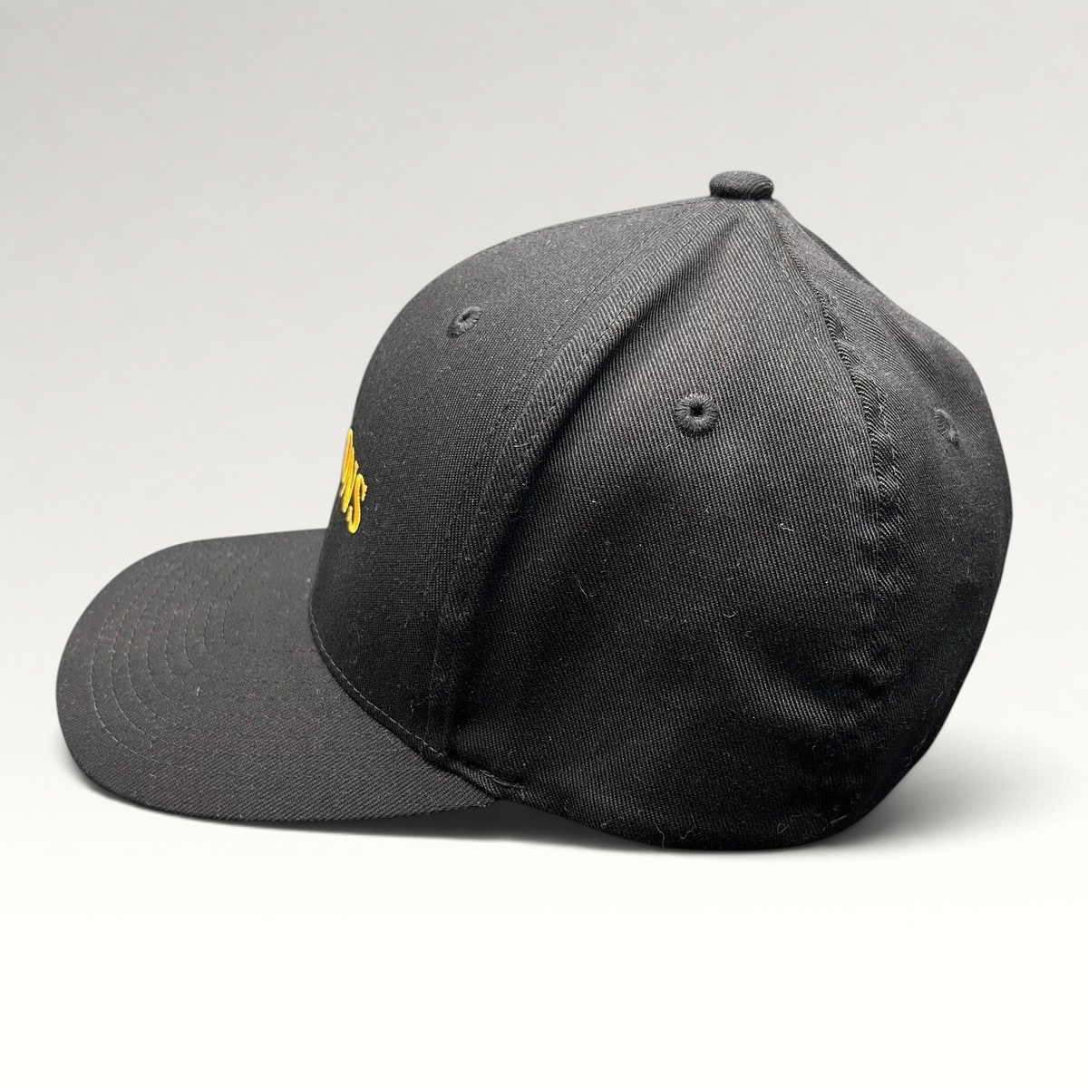 Raree Finds Billions TV show promotional black Yupoong Flexfit hat with gold embroidered logo on a structured crown