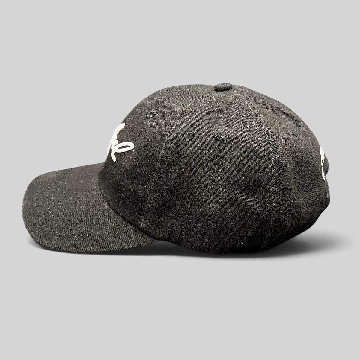 Raree Finds black Billy Joel In Concert strapback hat with white script embroidery and curved brim side view