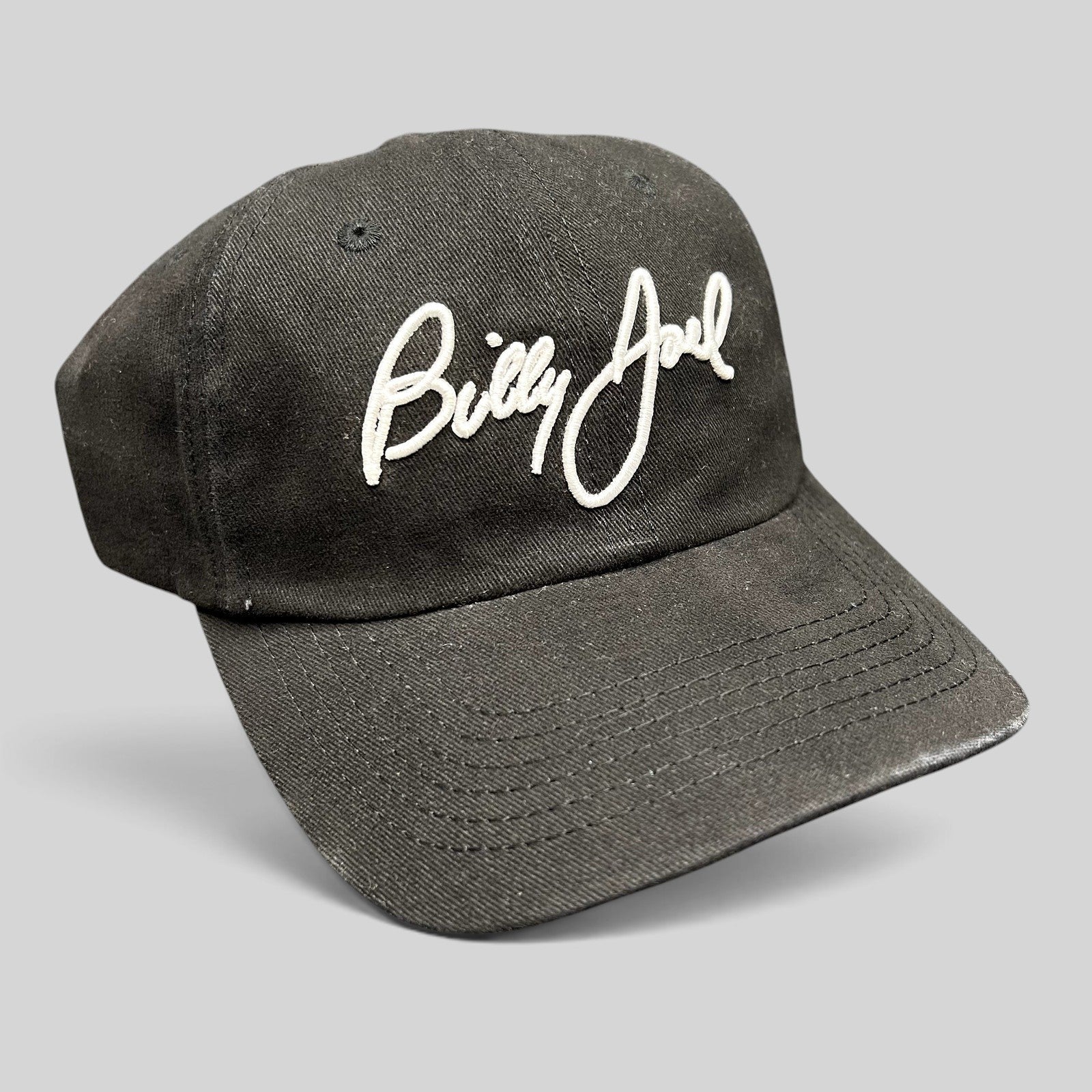 Raree Finds black Billy Joel concert strapback hat with white script embroidery on the front crown