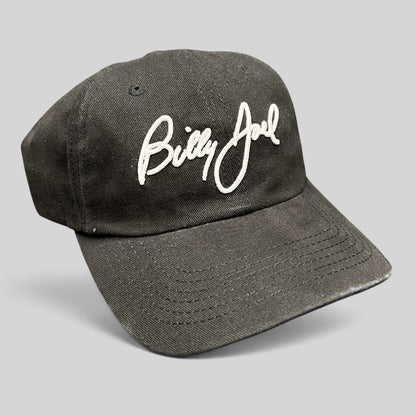 Raree Finds black Billy Joel concert strapback hat with white script embroidery on the front crown
