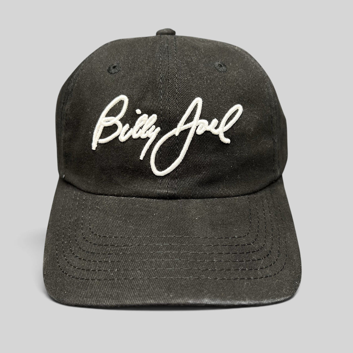 Raree Finds black Billy Joel In Concert strapback hat with white script embroidery on the front unstructured crown