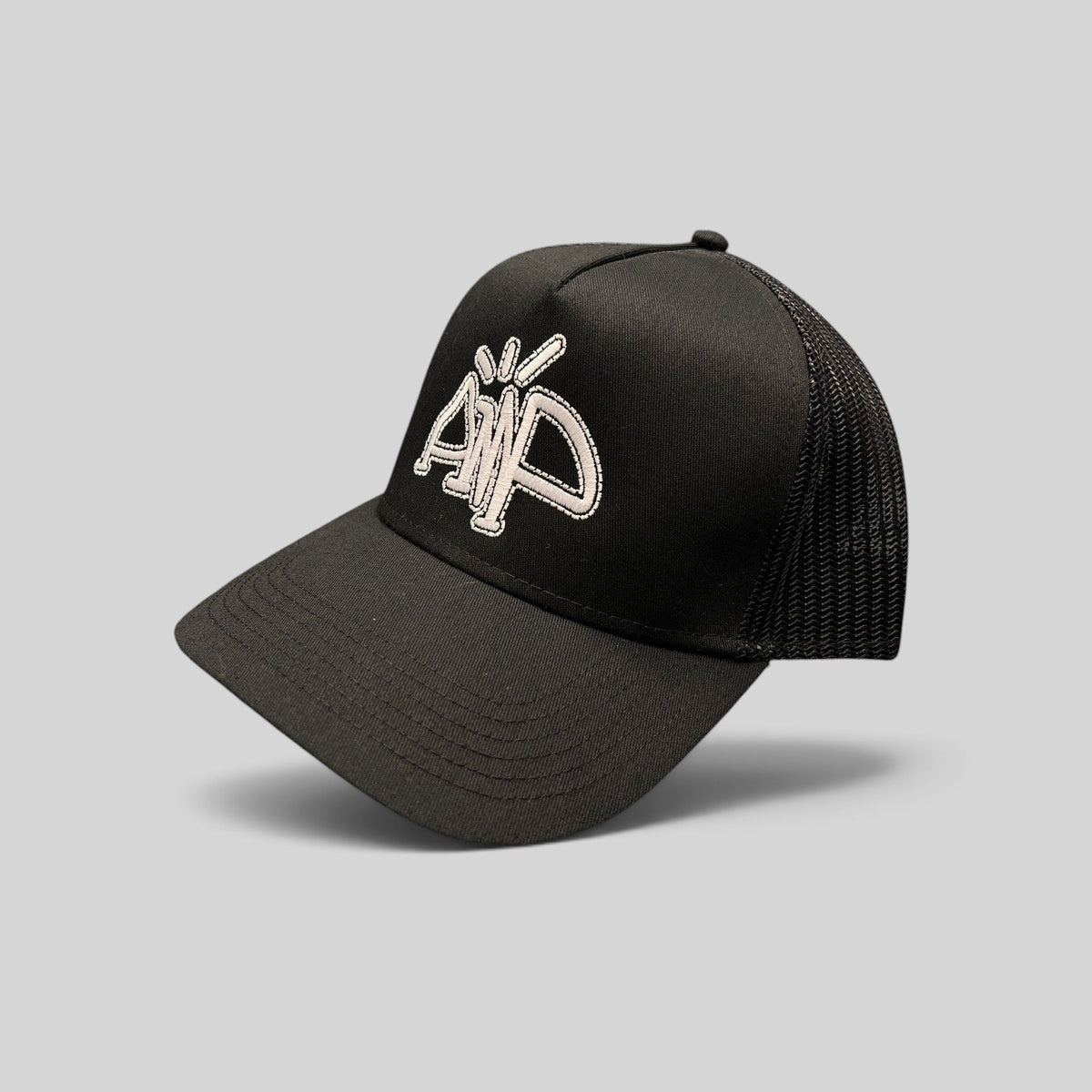 Raree Finds black mesh trucker hat with white embroidered AMP logo, structured crown, and adjustable snapback closure.