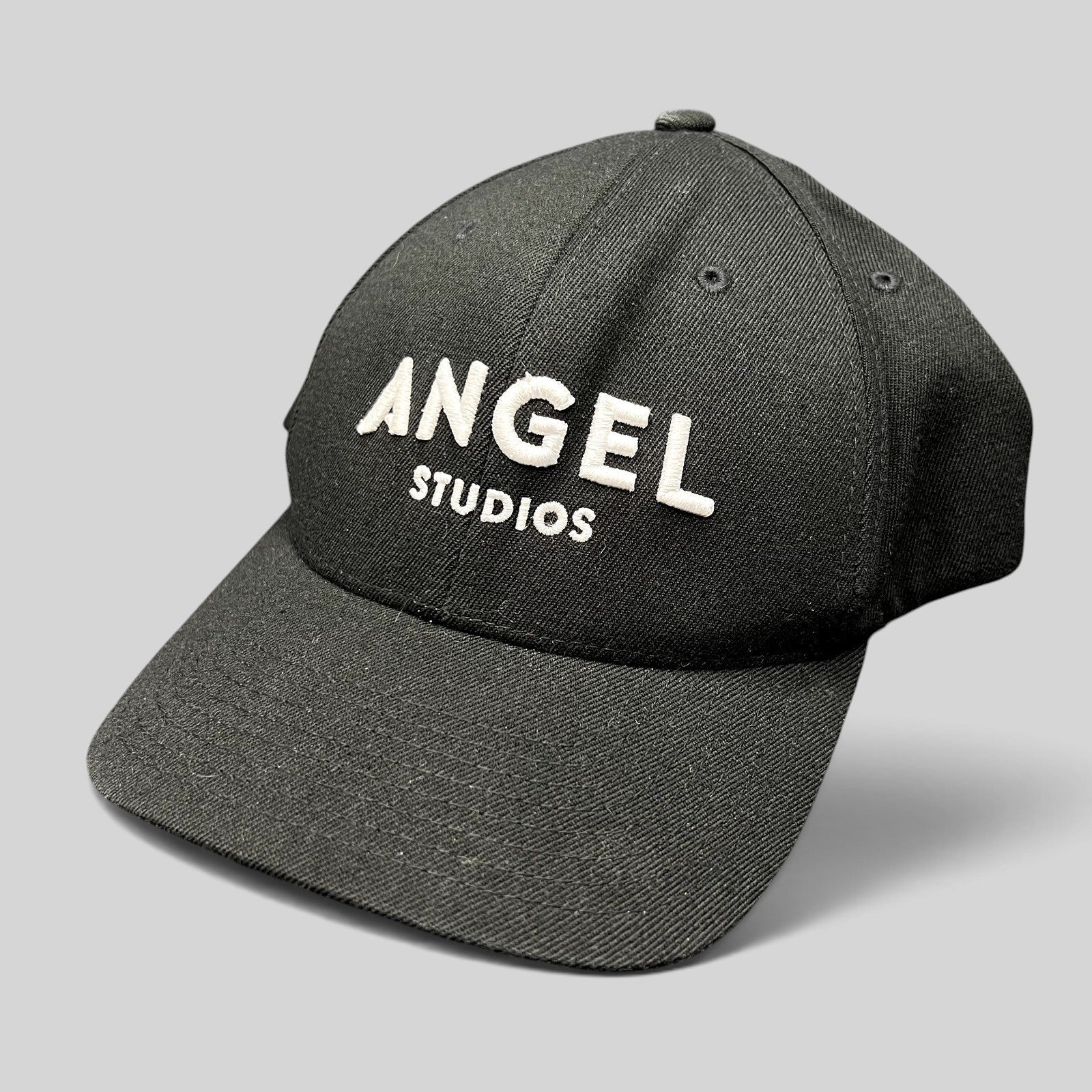 Raree Finds black Flexfit cap with white embroidered Angel Studios logo on a structured crown and curved brim