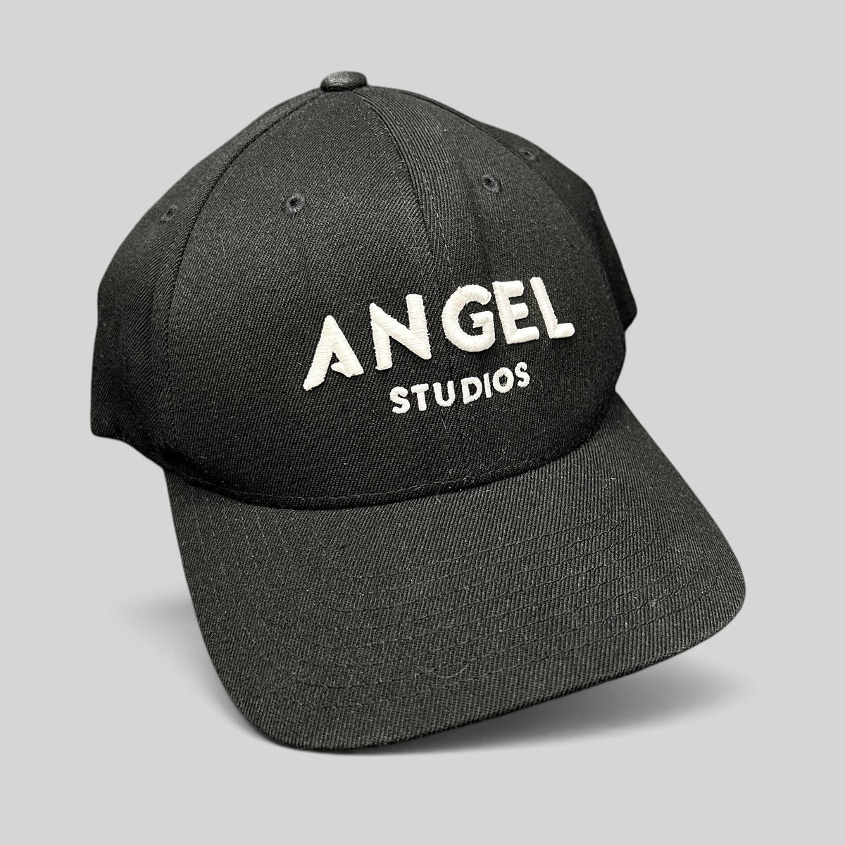 Raree Finds black Flexfit cap with white embroidered Angel Studios logo on a structured crown and curved brim